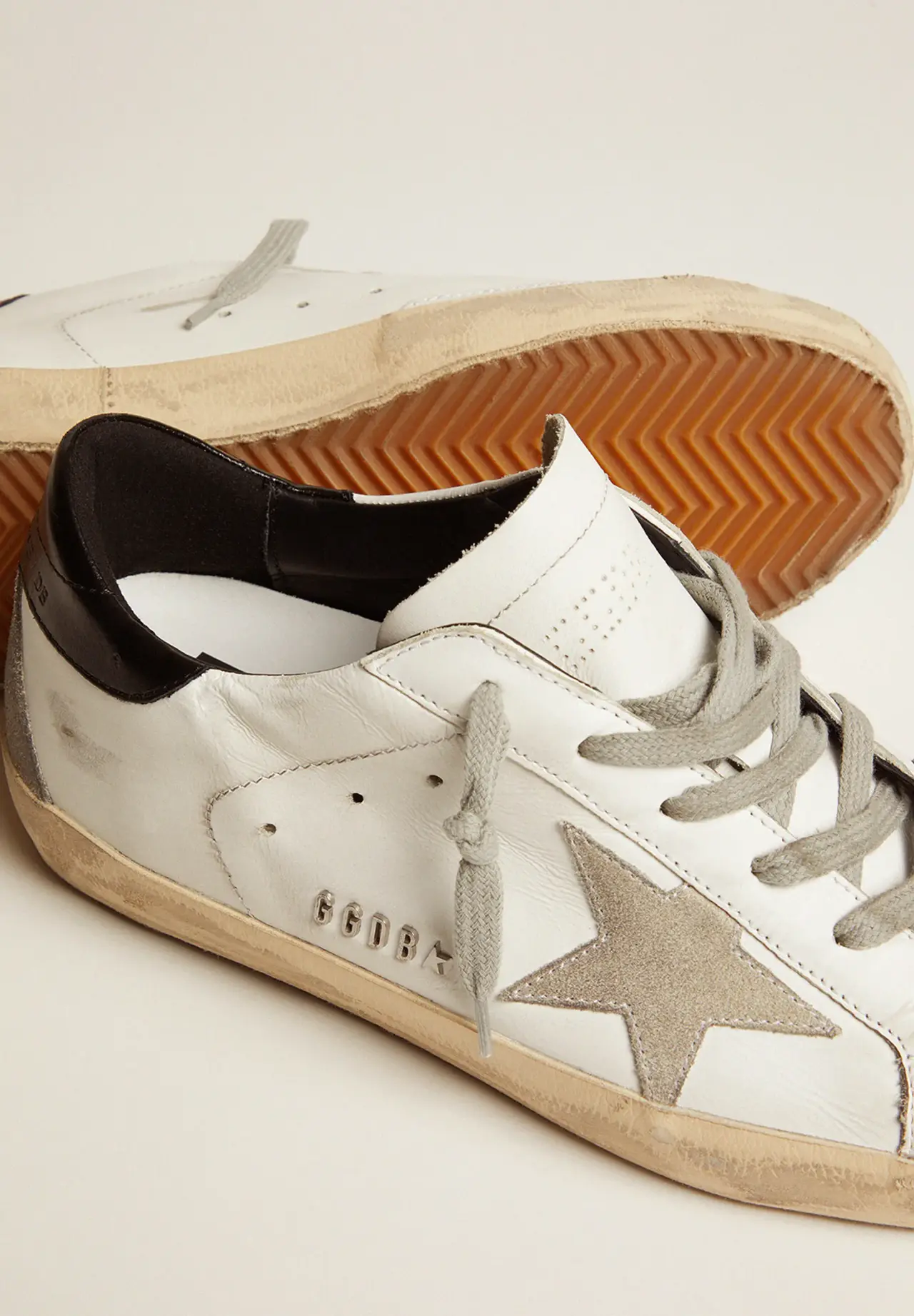 Super-Star sneakers with black heel tab and metal studs lettering
