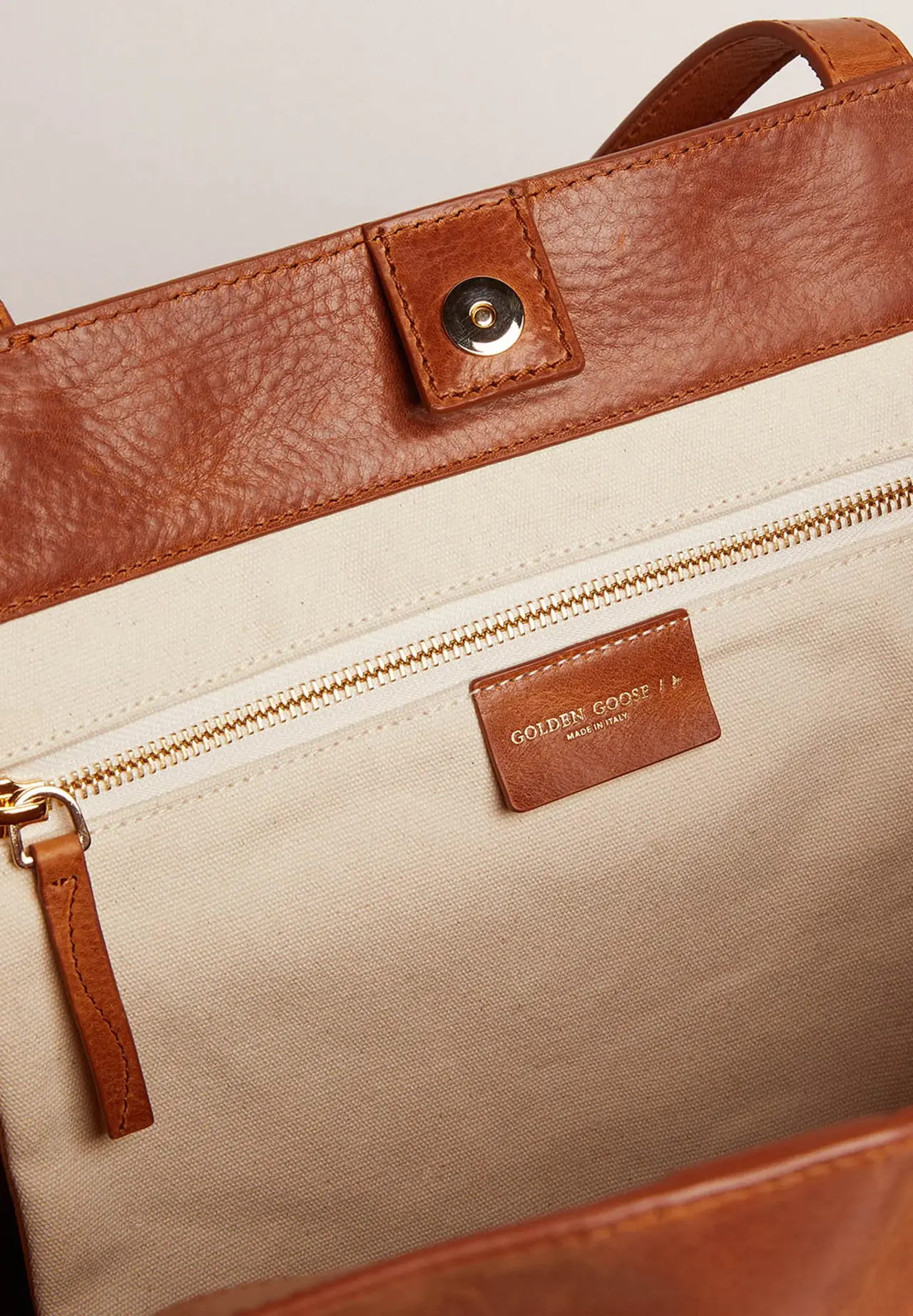 Pasadena Bag in tan-colored glossy hammered leather with gold logo on the front